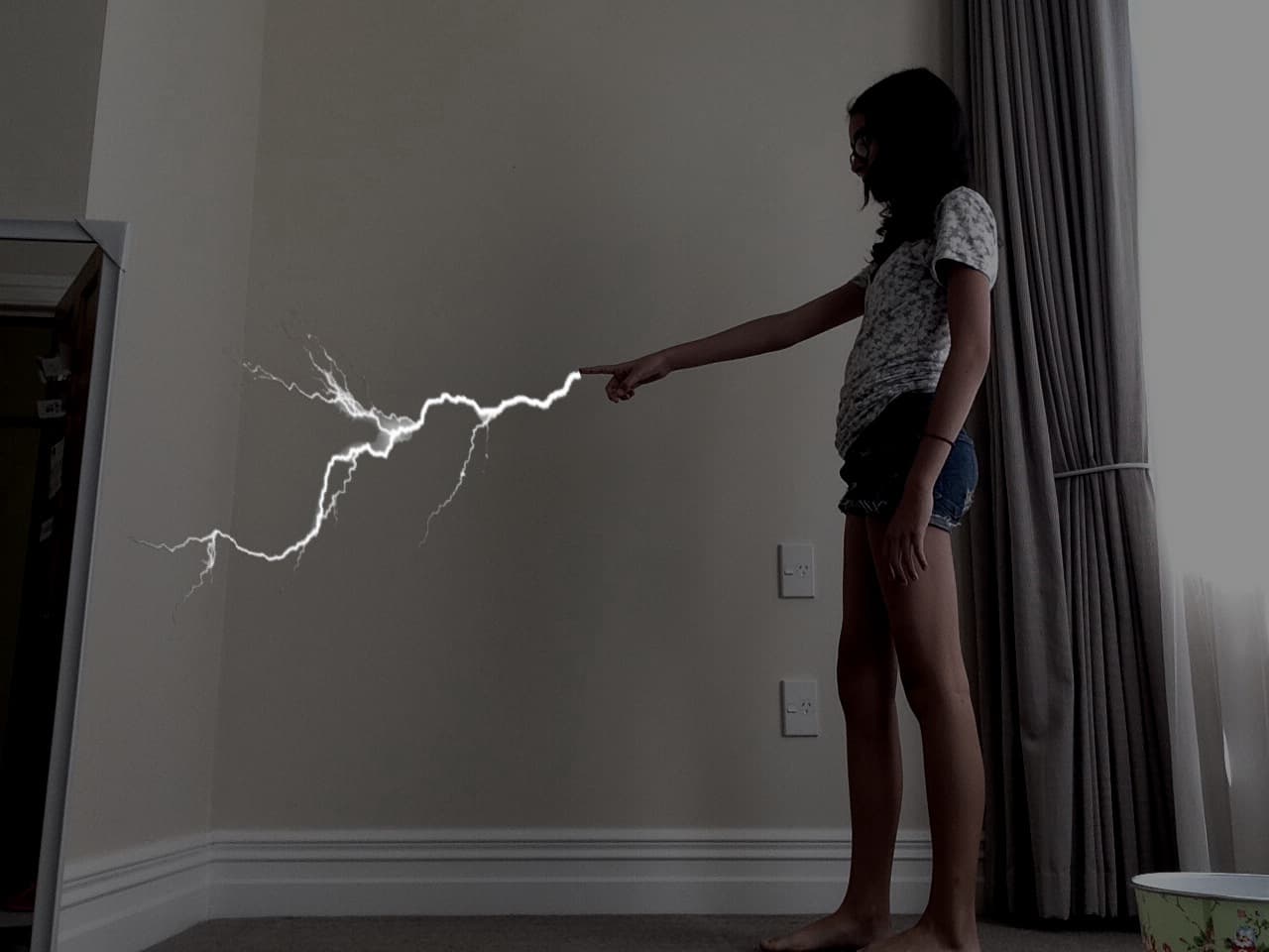 poorly edited black and white photo of me standing and pointing with lightning shooting out of my finger