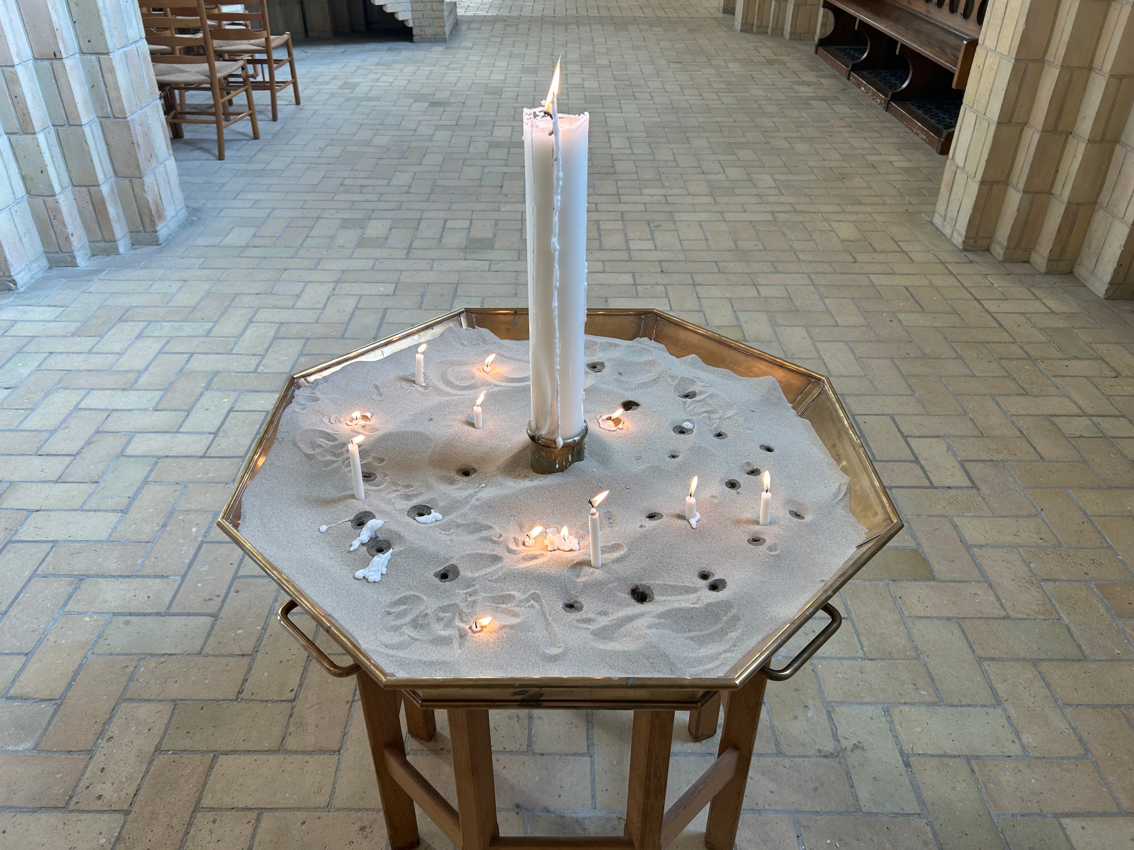 octagonal display with candles and white sand in grundtvig's kirke
